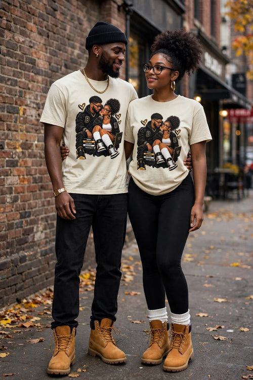A Love Built Different matching couple wearing cream vintage T-shirts on a city street